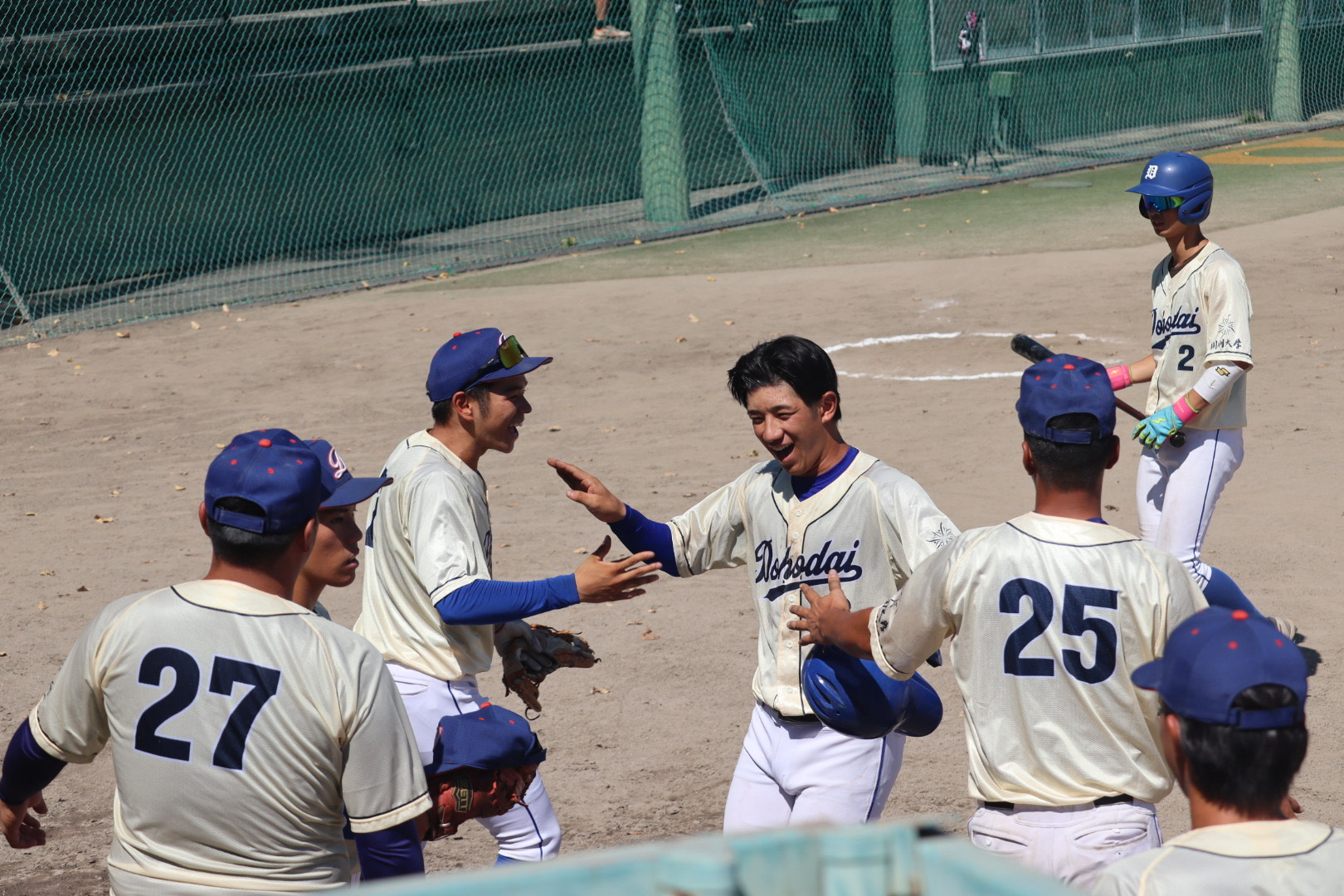 試合中のハイタッチをする学生
